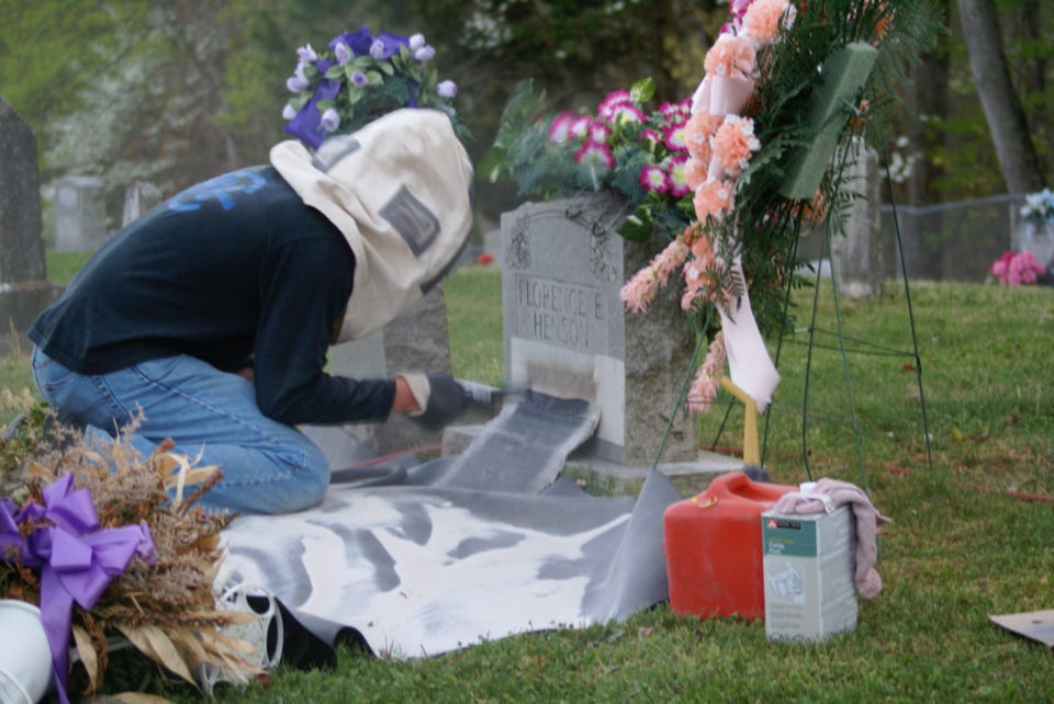 Ryan sandblasting a monument his grandfather made, decades ago.